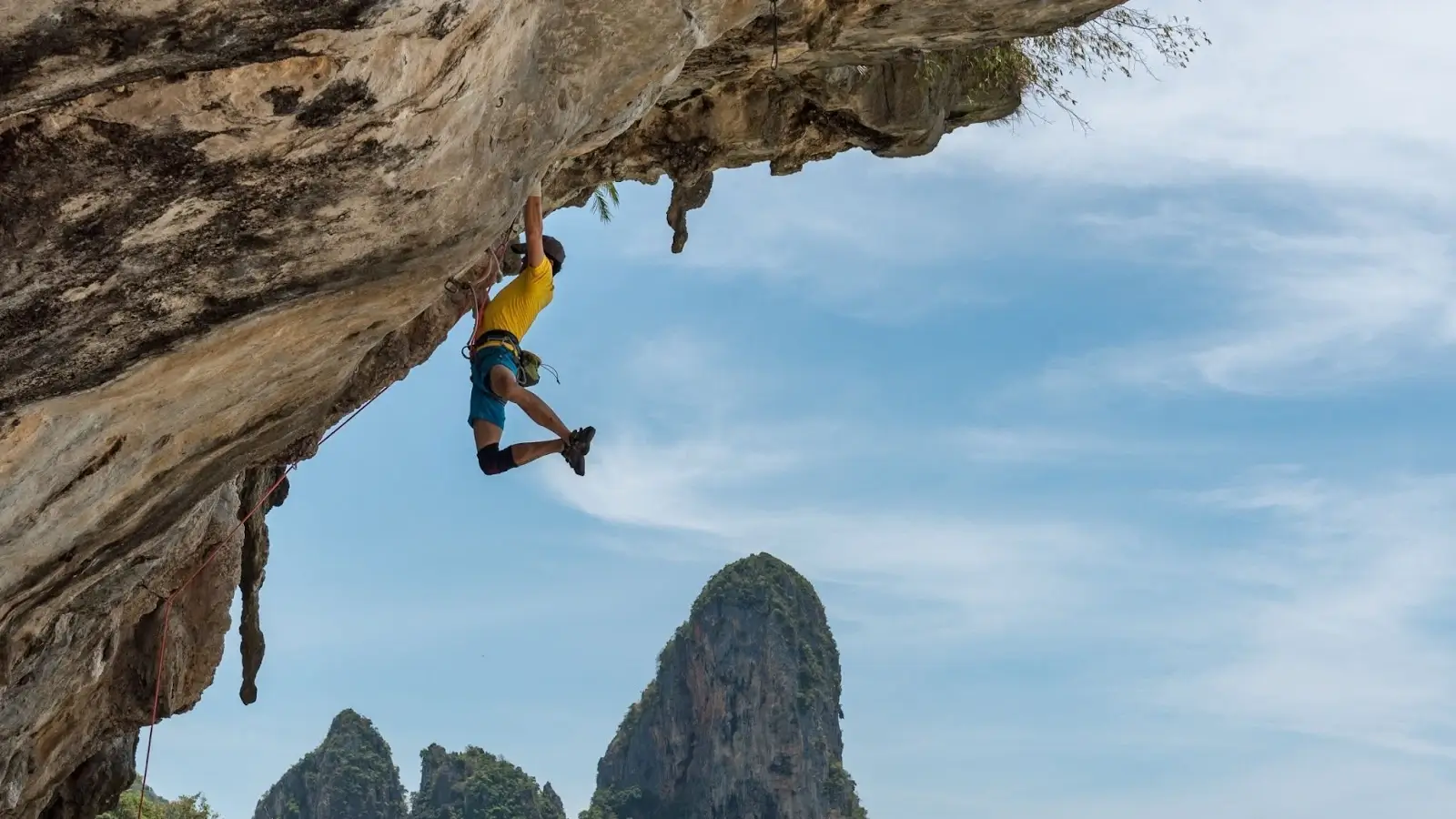 Climber hanging on rock face on Koh Tao