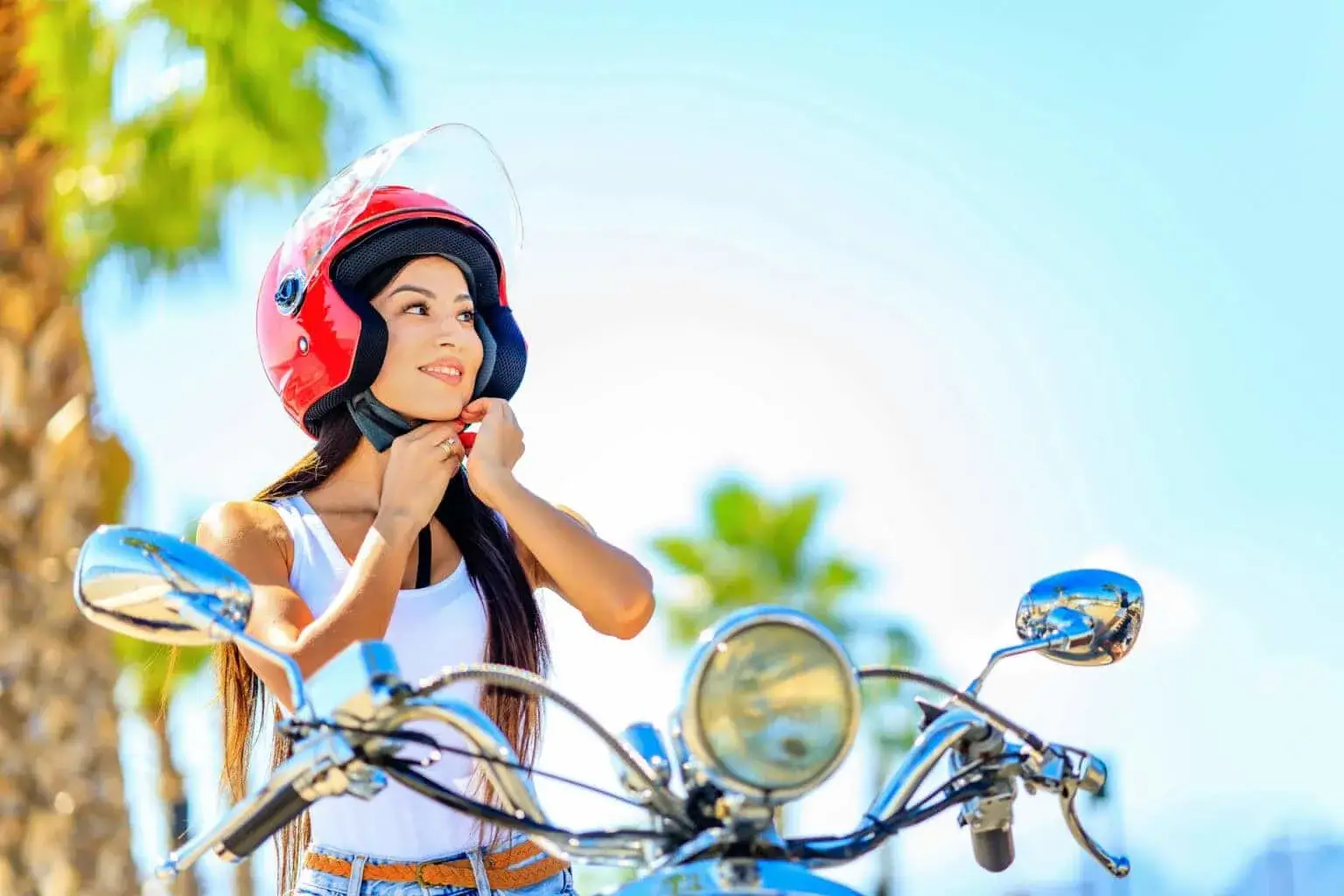 Girl wearing scooter helmet on beach