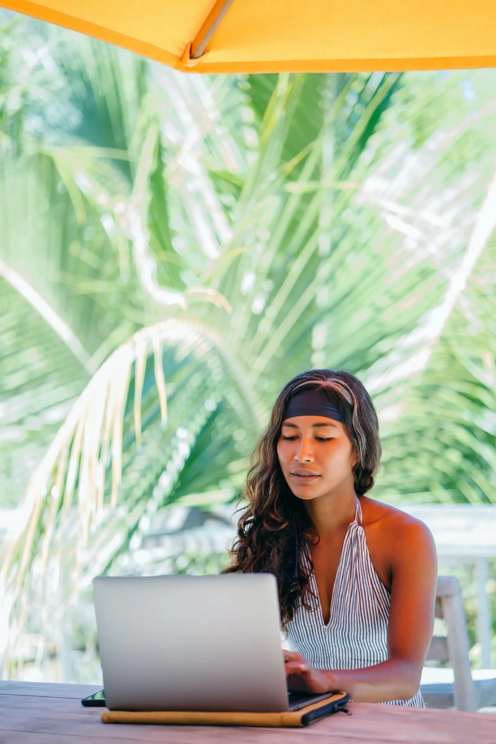 Trendy digital nomad girl working from a café on Koh Phangan